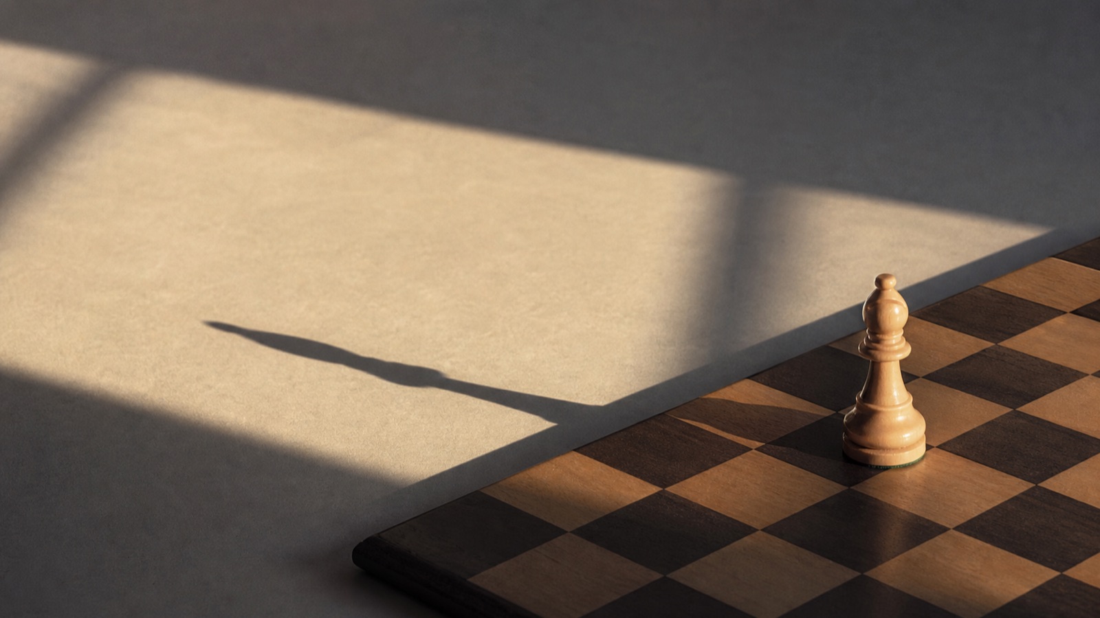 棋盤上一枚棋子，晨光斜灑拉出長影